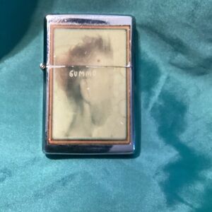 Vintage butane lighter with a picture of GUMMO, face is slightly faded.
